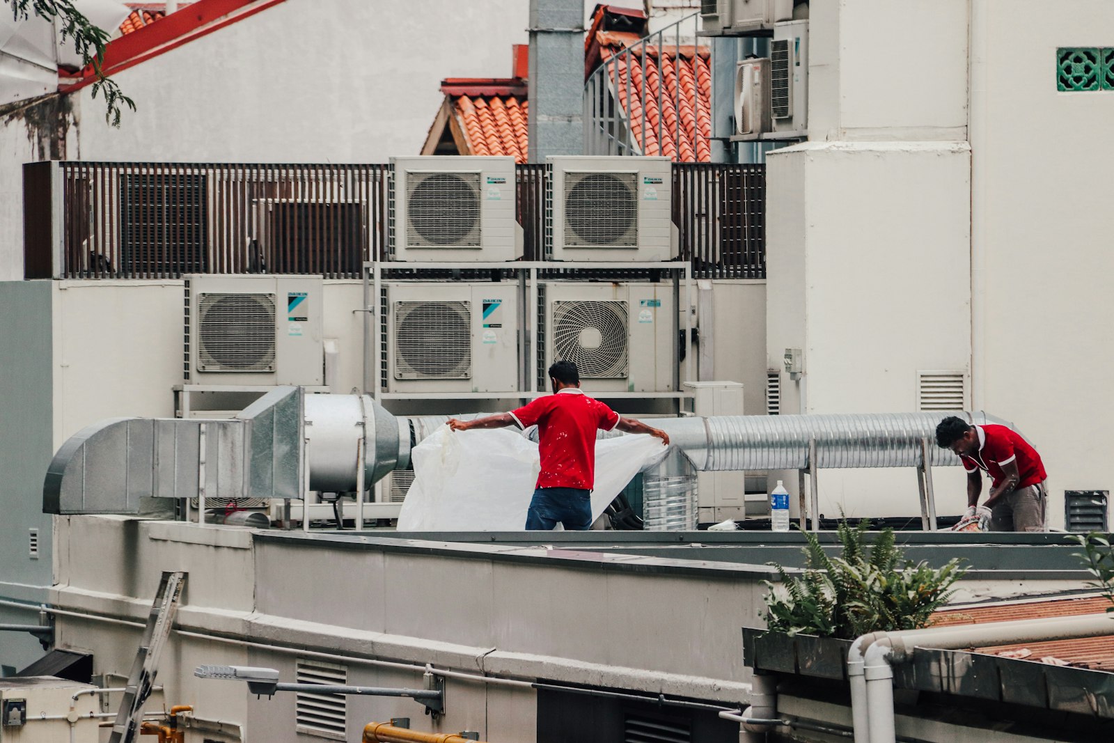 HVAC technician servicing a rooftop heating and cooling system